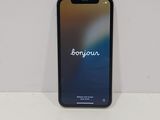 an iphone with the word bonjou on the screen sitting on top of a table