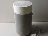 a white and gray speaker sitting on a table