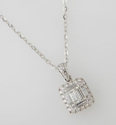 a white gold and diamond pendant with a baguet