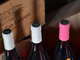 several bottles of wine are lined up in a wooden box