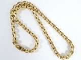 a close up of a gold chain on a white surface