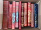 a box full of old books sitting on a table