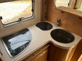 a kitchen with a sink and a window in the back of it
