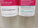 two bottles of lotion purifiate sitting on a counter top