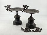pair of antique cast iron candlesticks on pedestals
