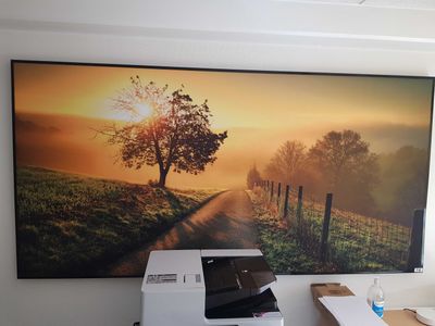 a picture of a picture hanging on the wall of a home office