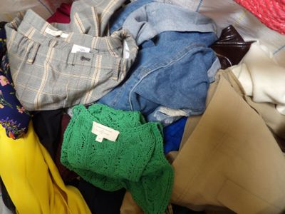 a pile of clothes that is sitting in a suitcase