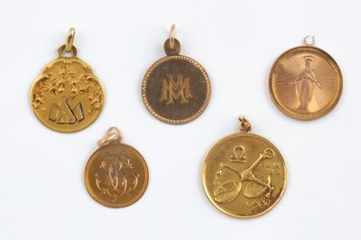 four gold and silver medallions of various sizes and shapes