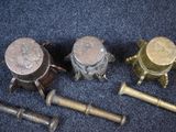 several different types of old brass items on a blue carpet