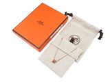 an orange box with a necklace and a small bag