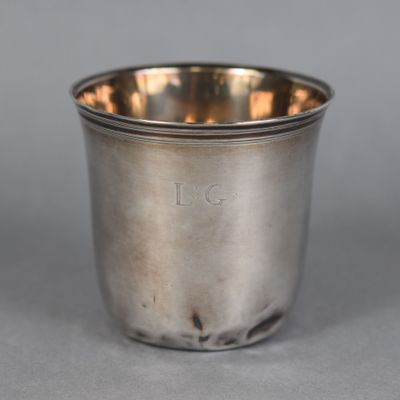 a close up of a silver cup sitting on a table