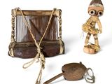 a small wooden box with a doll and other items on it
