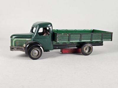 a green toy truck with a man inside of it