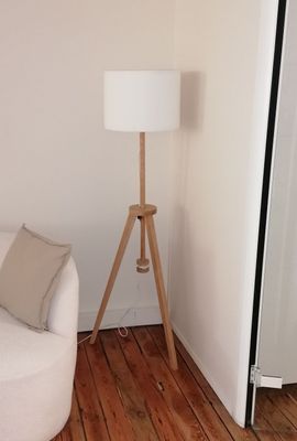 a white chair and a white lamp in a living room