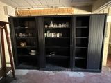 a black cabinet with glass doors in a room