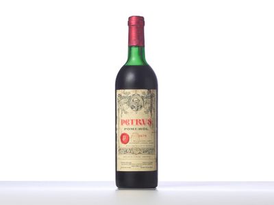 a bottle of red wine sitting on top of a table