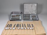 a lot of silverware in a case on a table