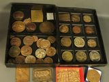 a box of coins sitting on a table next to a box of coins