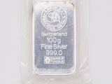 a close up of a silver bar in a package on a white surface