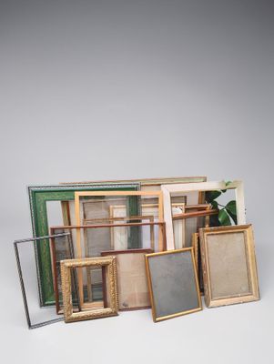a lot of picture frames sitting on a table