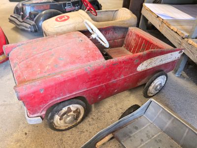 a red toy truck that is sitting in the garage