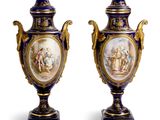 pair of blue and gold vases with figures painted on them