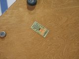 a small piece of paper on the floor next to a door