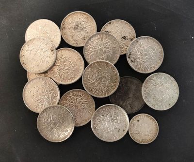 some silver coins are sitting on a black surface