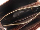 a brown purse with a gold zipper on it