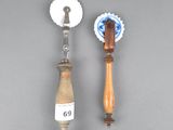 pair of wooden handles and a bottle opener on a gray surface