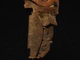 a wooden sculpture of a man ' s head on a stand