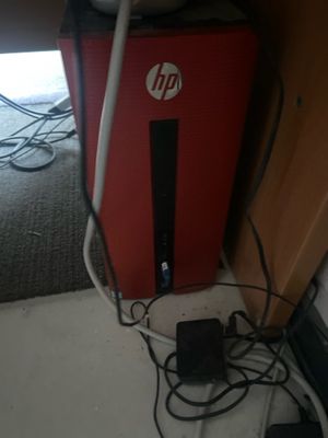 a computer and a mouse on the floor under a desk