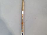 a gold colored pen sitting on top of a white table
