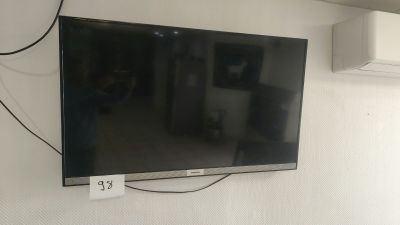 a flat screen tv mounted on a wall in a room