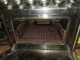 an oven with a lot of cooking items inside of it