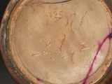 a close up of a brown vase with writing on it
