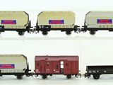 four different types of train cars on a white surface