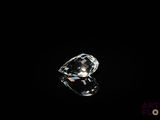 a close up of a diamond on a black surface