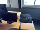 a desk with a keyboard and a monitor on it