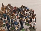 a lot of figurines that are on display in a glass case