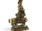 statue en bronze représentant un homme à cheval, avec un chien sur le dos