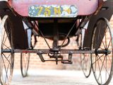a horse and buggy that is parked in front of a brick building