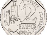 an image of a silver coin with the number two on it