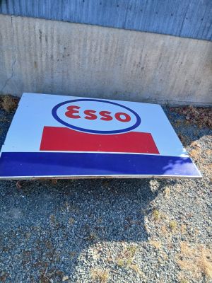a close up of a sign on the ground near a building
