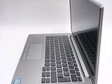 a silver laptop computer sitting on top of a white table
