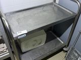 a metal cart that is sitting in a bathroom