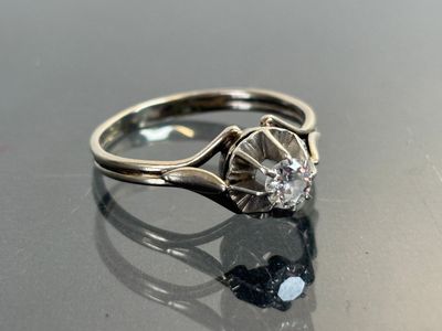 an image of a diamond ring on a shiny surface