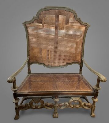 an old chair with a cane back and a cane seat on it