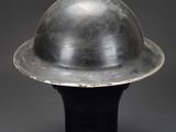 a close up of a metal helmet on a black base