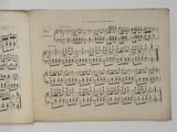 an old book with a page of music written on it